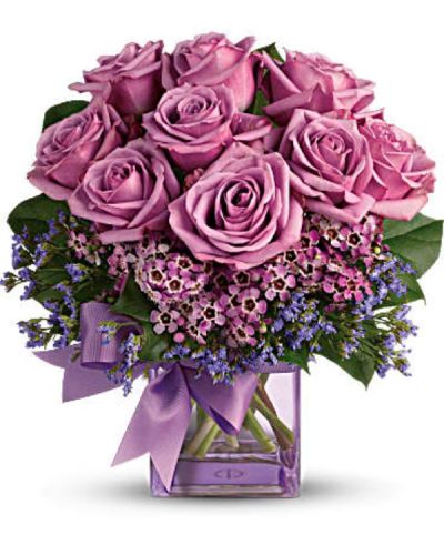 <div id="mark-1" class="m-pdp-tabs-marketing-description">Fresh as morning dew. Beautiful blooms in all shades of purple are gathered into a purple glass cube vase and tied with a purple bow. How perfectly purple!</div>
<div id="desc-1">
<ul>
 	<li>A pretty taffeta ribbon puts the finishing touch on this presentation of lavender roses, lavender waxflower, purple limonium and rich green salal.</li>
 	<li>Delivered in a glass cube vase.</li>
</ul>
</div>
