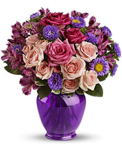 Elegance without extravagance, this magnificent bouquet features a gorgeous blend of pink roses and lavender favorites in a classic ginger jar of translucent purple. The effect is stunning!
The elegant bouquet includes hot pink roses, light pink spray roses, lavender alstroemeria, lavender matsumoto asters and lavender cushion spray chrysanthemums accented with fresh greenery.