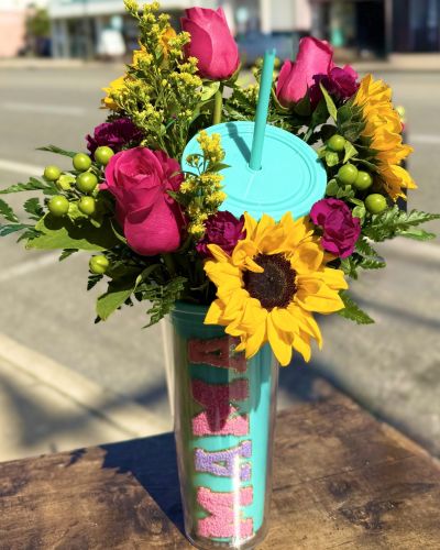 Bright pink roses, Florida sunflowers and sweet mini carnations fill this keepsake tumbler cop for Mom to enjoy again and again!
