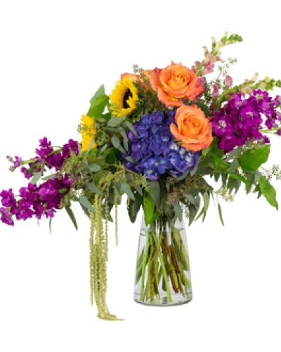 The Joyful Wonder Bouquet is an artful display of vivid color that delivers joy with every glance. Featured flowers include snapdragons, stock, hydrangea, sunflowers and roses.