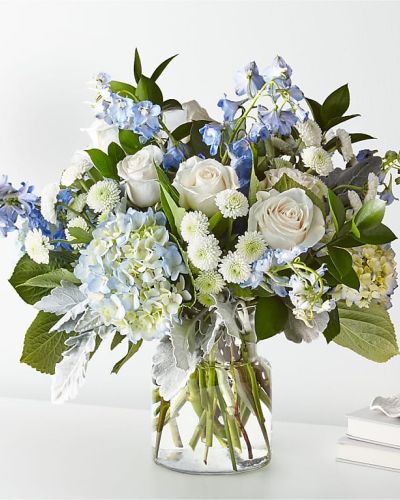 Let this uplifting arrangement be reminders of the clear skies ahead. Capturing the feeling of hope that a new day brings, this bouquet is composed of voluminous hydrangea blooms and vibrant belladonna delphinium to refresh their mood.