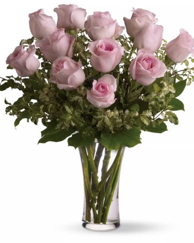 <p>twelve stems of pink roses accented with complimenting filler and fresh greens presented in a clear glass vase</p>