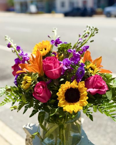 <p>Vibrant colors, fragrant stock, sunny sunflowers, rich hot pink roses round out this stunning bouquet.</p>