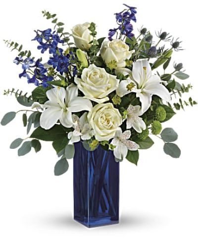 <p>With its deep cobalt glass vase and pure white blooms, this soothing bouquet is a stylish gesture for any special occasion!<br />
This arrangement includes white roses, white asiatic lilies, white alstroemeria, green button spray chrysanthemums, blue eryngium, bupleurum, spiral eucalyptus, silver dollar eucalyptus, and lemon leaf.</p>