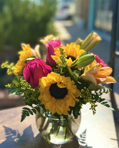 Florida sunflowers, pink roses and orange lily's fill this sweet bubble bowl. These rich vibrant colors are sure to receive a SMILE!