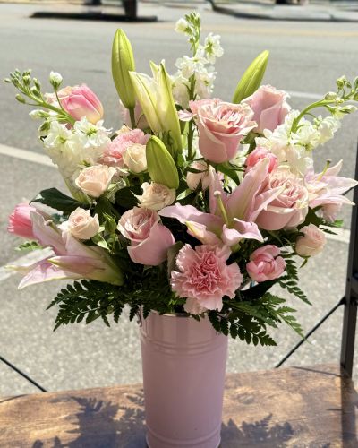 <p>Fragrant lilies and Stock!</p>
<p>Roses and spray roses!</p>
<p>Tulips and carnations!</p>
<p>All in pinks and whites designed in our keepsake pink vase.</p>