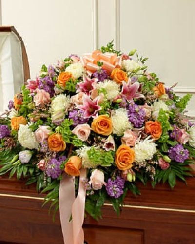 Their life was filled with beauty and joy. Remember all the love and happiness they shared with this casket cover arrangement in soothing and delicate pastel shades. Our expert florists create this half casket cover with fresh pastel blooms such as long-stem roses, lilies, mums, Bells of Ireland, stock, lisianthus, heather and more. Traditionally sent by the immediate family to the funeral home.