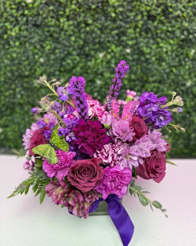 <p>Compact bouquet of magenta roses, pink daisies, purple carnations butterflies and more</p>