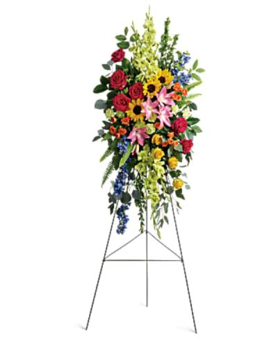 <div id="mark-1" class="m-pdp-tabs-marketing-description">A bold, bright tribute, this rainbow of blooms fills the room with a spirit of hope and joy. What a glorious celebration of a love that will live on forever.</div>
<div id="desc-1">
<ul>
 	<li>This spray features hot pink roses, yellow roses, orange spray roses, pink asiatic lilies, green gladioli, green carnations, medium yellow sunflowers, blue delphinium, bupleurum, myrtle, sword fern, silver dollar eucalyptus, and lemon leaf.</li>
 	<li>Delivered on a wire easel.</li>
</ul>
</div>